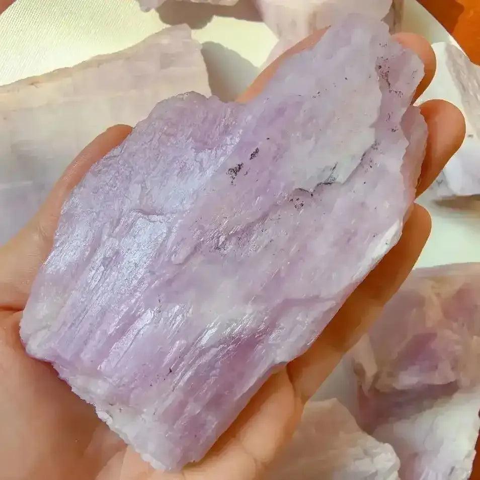 Raw pink kunzite crystal with a glassy, lilac-toned rough texture, perfect for heart chakra healing and meditation.