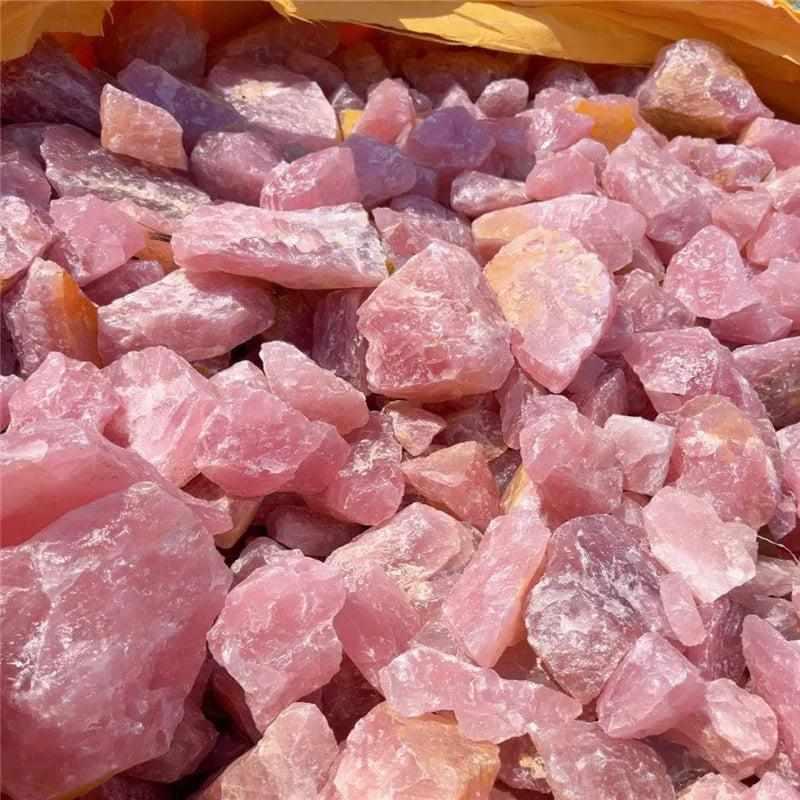 Raw rose quartz stones with natural rough surfaces and soft pink hues, perfect for heart chakra healing and home decor.