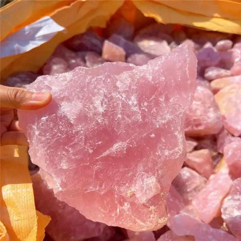 Large, raw rose quartz crystal with a soft pink hue and natural, unpolished texture for heart chakra healing and decor.