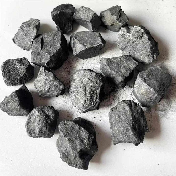Raw Shungite pieces with a matte black, unpolished natural texture for root chakra protection and home purification.
