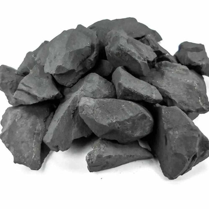 Raw Shungite stones with a matte black, unpolished natural surface for protection and root chakra grounding.