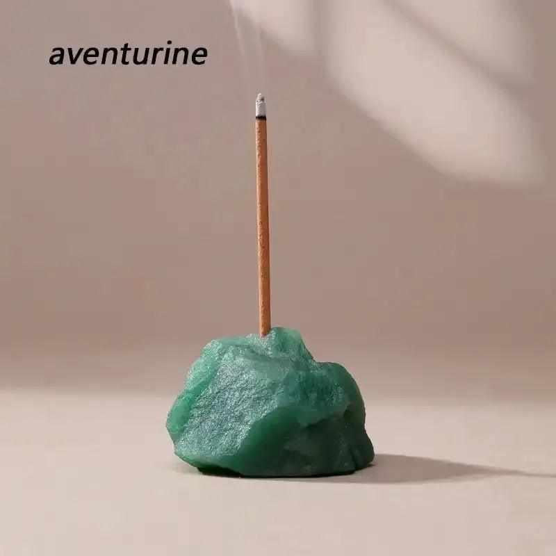 Green aventurine raw stone incense holder with a rough, natural texture and a centered opening for a calming ritual.