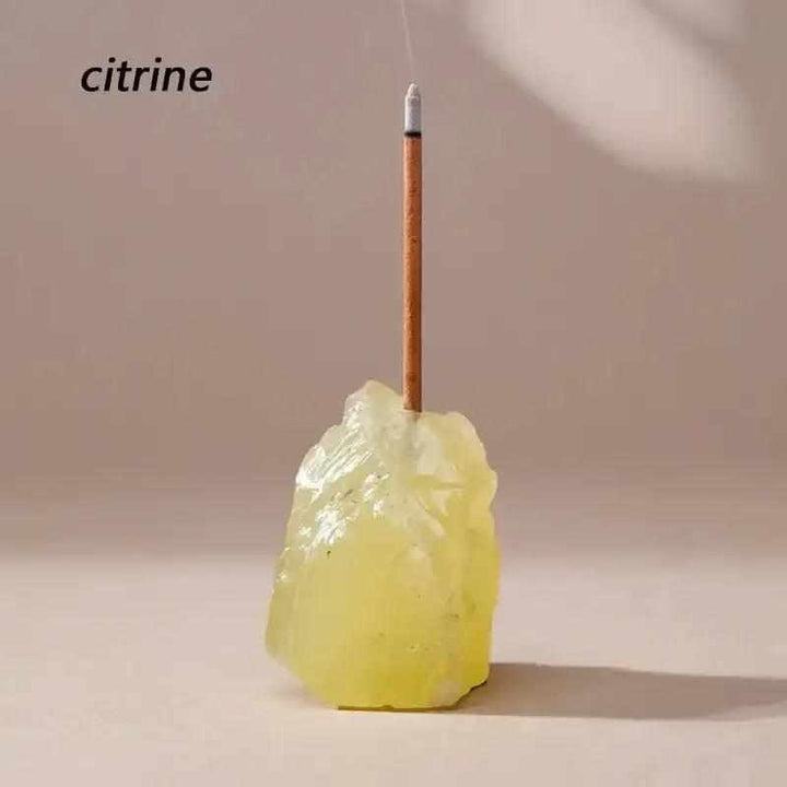 Raw Citrine stone incense holder with a rough, yellow mineral texture and a drilled opening for a slender incense stick.