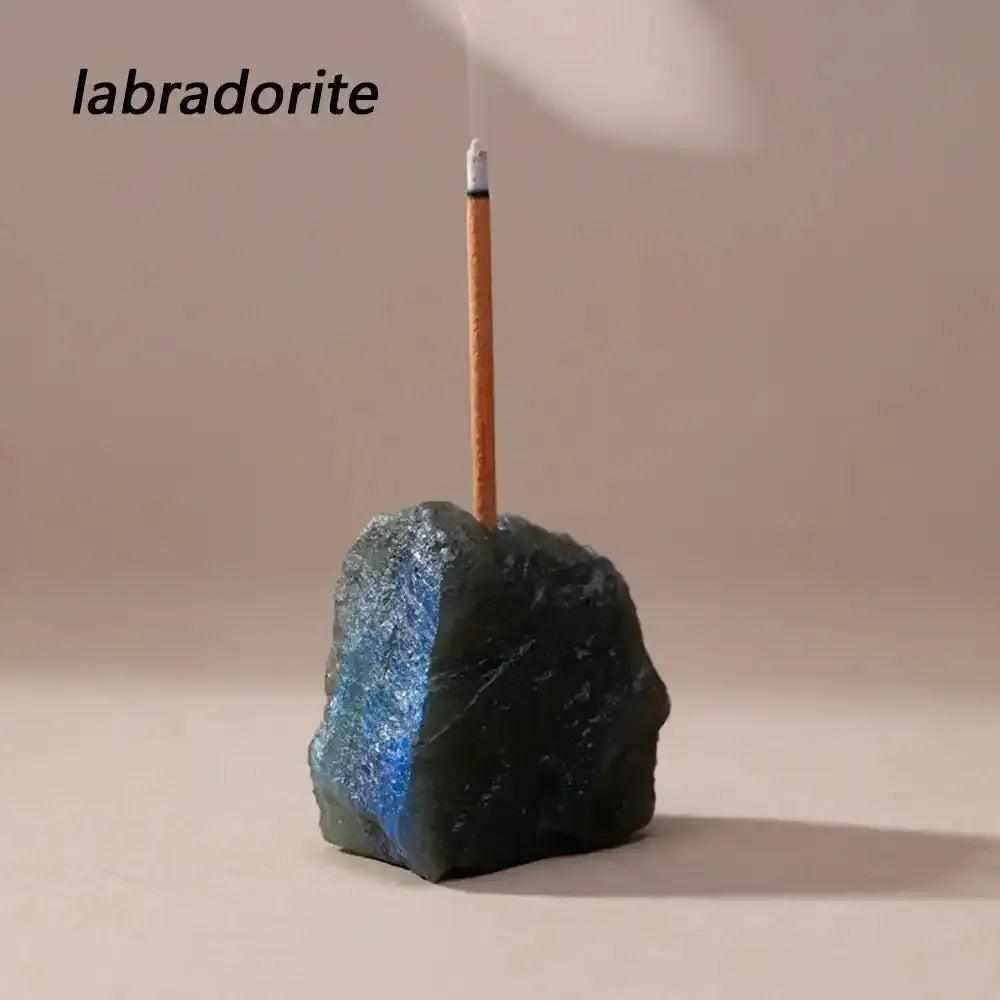Raw Labradorite stone incense holder with a rough, iridescent texture and a drilled opening for a calming ritual.