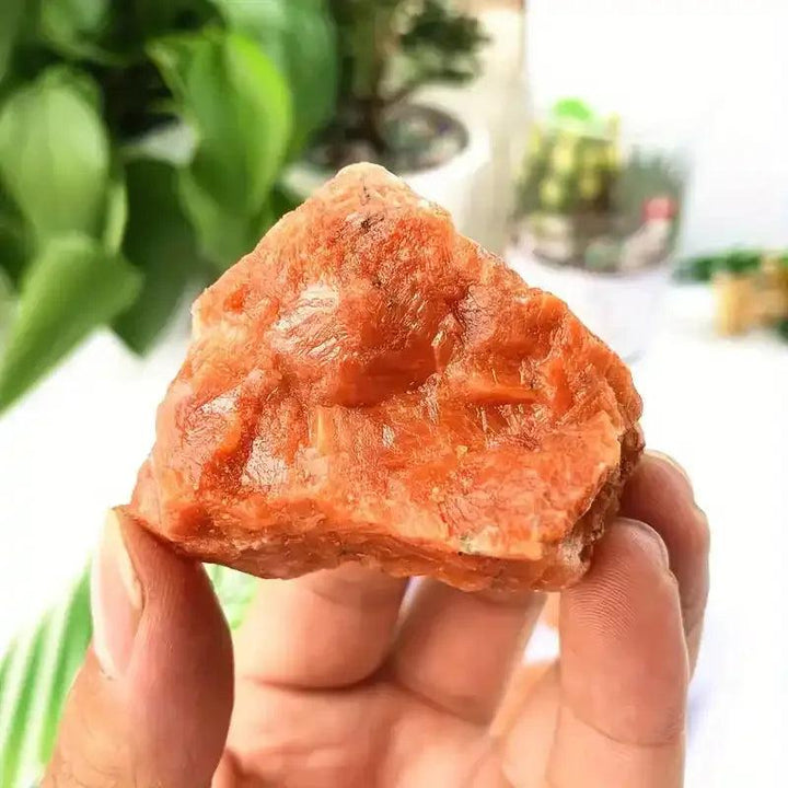 Raw sunstone chunk with a warm orange, glittery shimmer, perfect for boosting optimism and solar plexus energy.