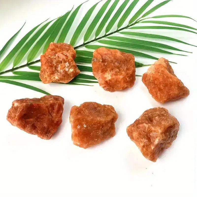 Raw sunstone chunks with warm orange, glittery shimmer and natural, unpolished texture for energy and personal power.
