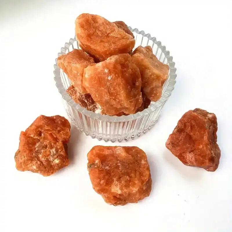 Raw Sunstone chunks featuring warm orange, glittery textures for energy, vitality, and solar plexus chakra healing.