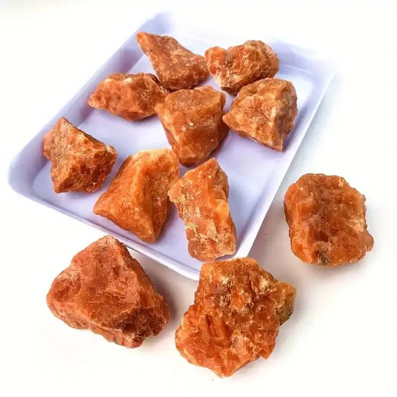 Raw sunstone chunks with warm orange, glittery texture, perfect for solar plexus chakra energy and natural crystal healing.