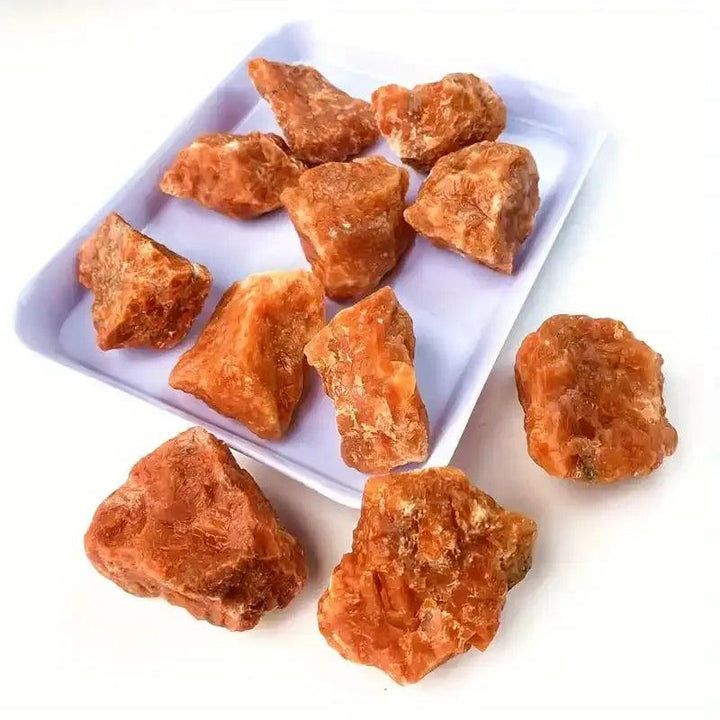 Raw sunstone chunks with warm orange, glittery texture, perfect for solar plexus chakra energy and natural crystal healing.
