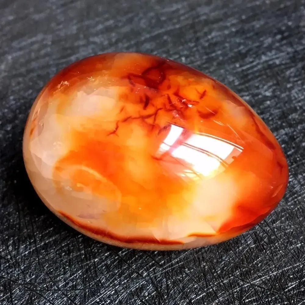 Polished Red Agate Crystal Egg, vibrant crimson to warm cream, for grounding and Root Chakra vitality.