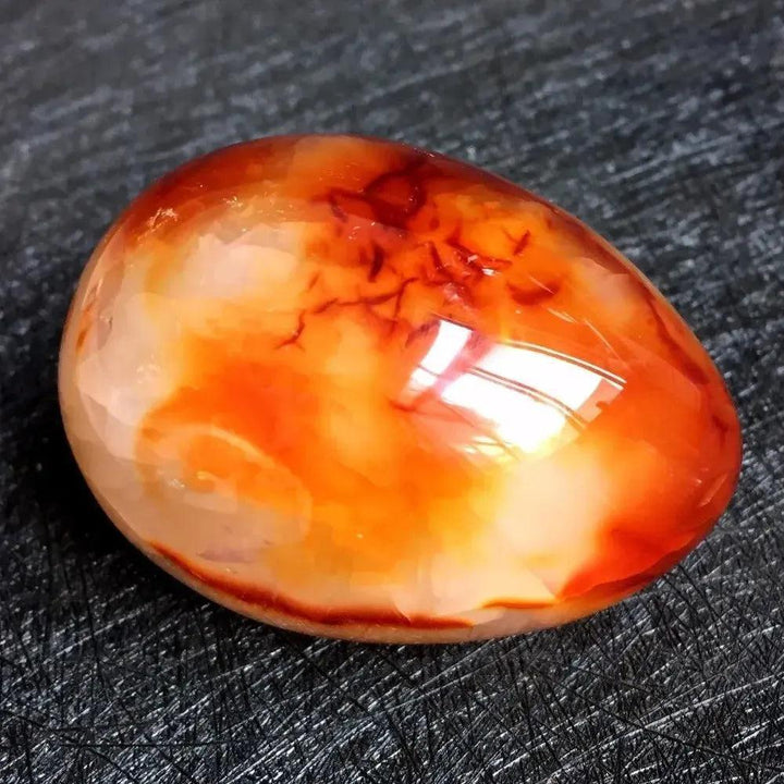 Polished Red Agate Crystal Egg, vibrant crimson to warm cream, for grounding and Root Chakra vitality.