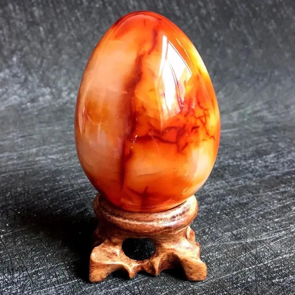Polished Red Agate Crystal Egg, vibrant crimson to orange, for grounding Root Chakra healing and vitality.