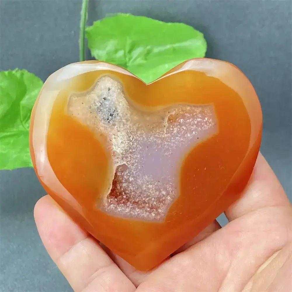 Natural Red Agate Heart Geode: Polished red agate heart with sparkling druzy crystals, promoting strength and balance.