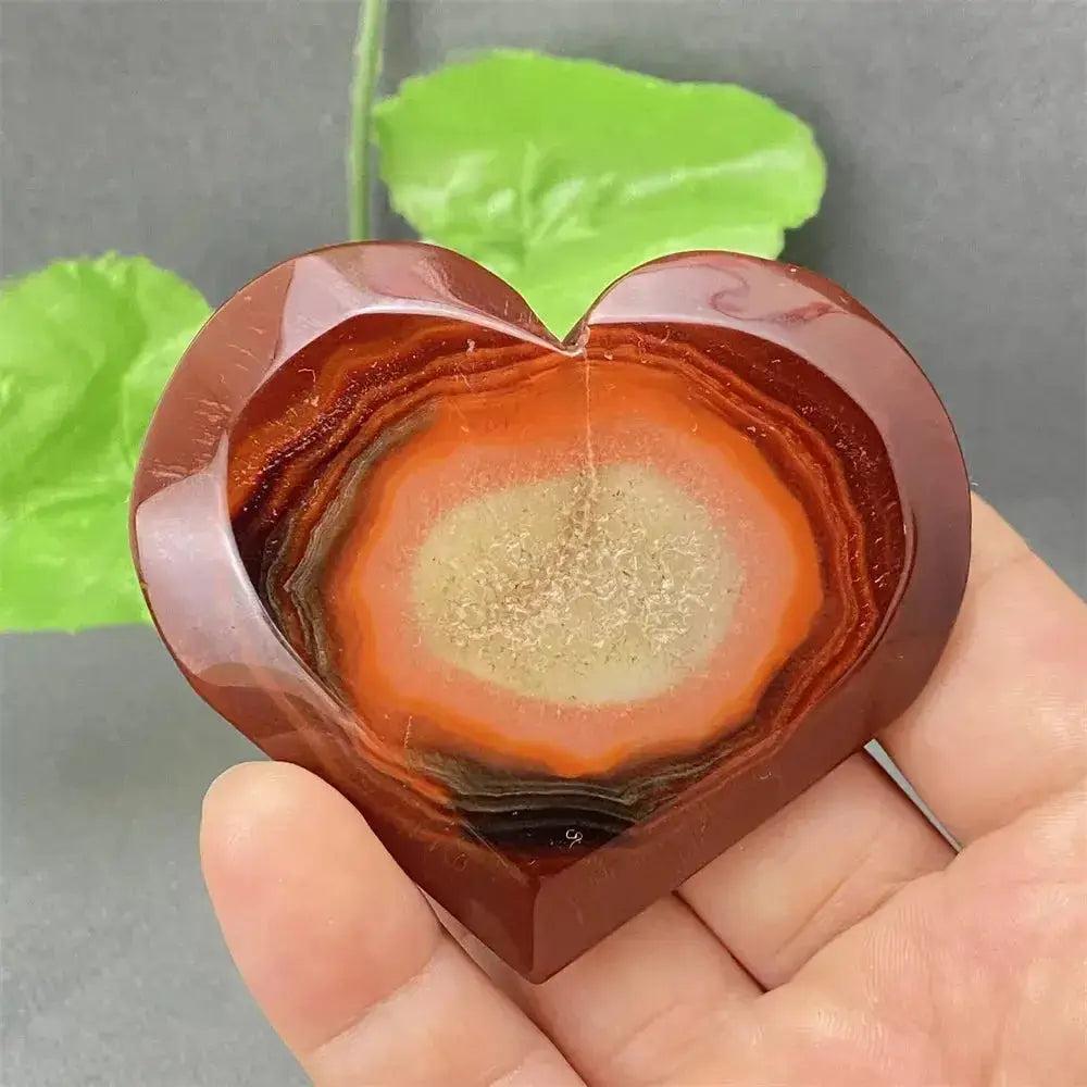 Natural Red Agate Heart Geode: Polished red heart with sparkling druzy crystal interior, promoting strength and balance.