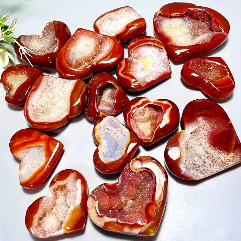 Polished red agate heart-shaped stones with sparkling natural crystal geode centers.