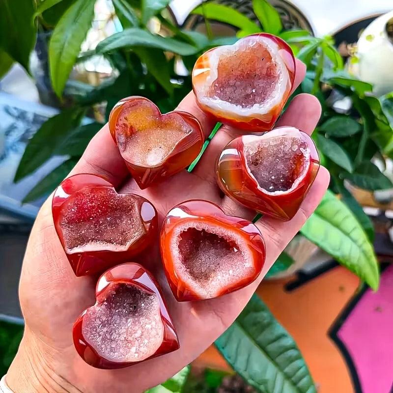 Polished red agate heart-shaped stones with sparkling natural crystal geode centers.