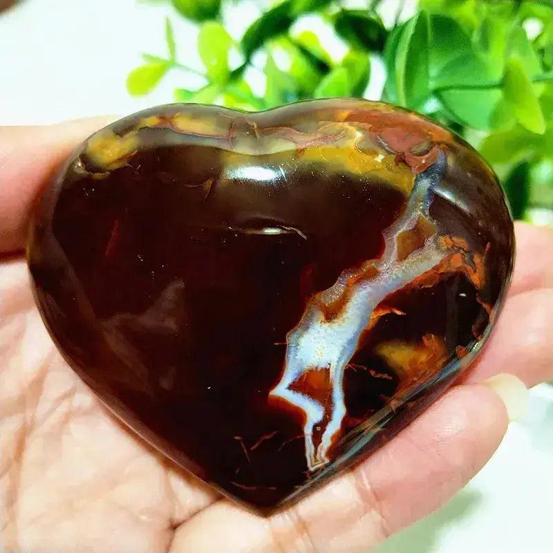Polished Red Agate heart, a grounding Root Chakra stone, showcasing rich red, brown, and white banding.