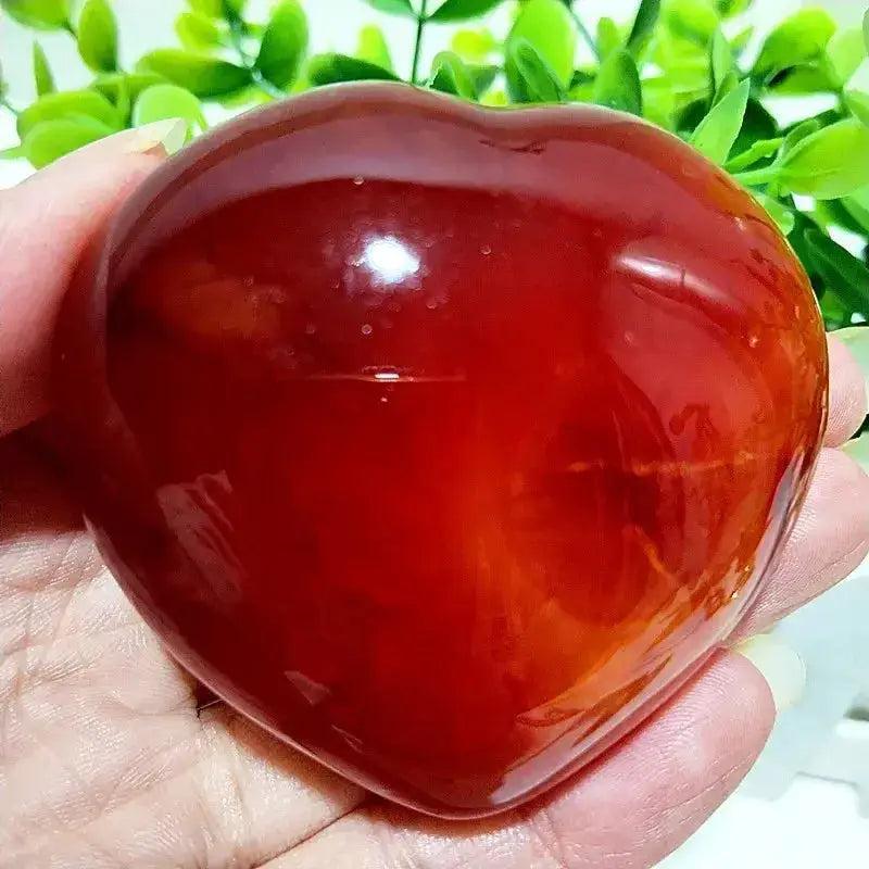 Polished Red Agate heart, a grounding vitality stone, radiating warm, earthy tones for root chakra activation.
