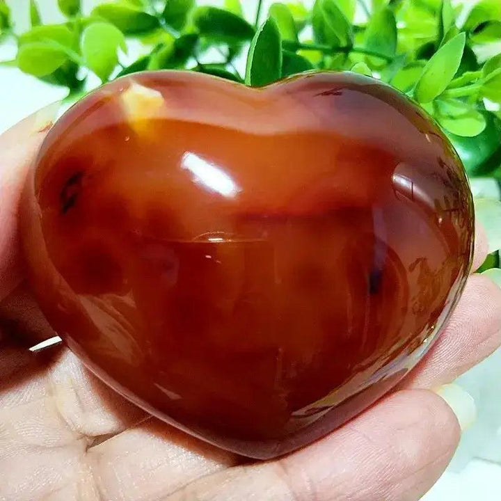 Polished Red Agate heart, a grounding root chakra stone, radiating vibrant vitality and emotional balance.