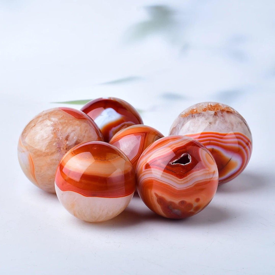 Red Banded Agate Crystal Polished Spheres, showcasing deep crimson, rust, and terracotta layers for grounding and vitality.