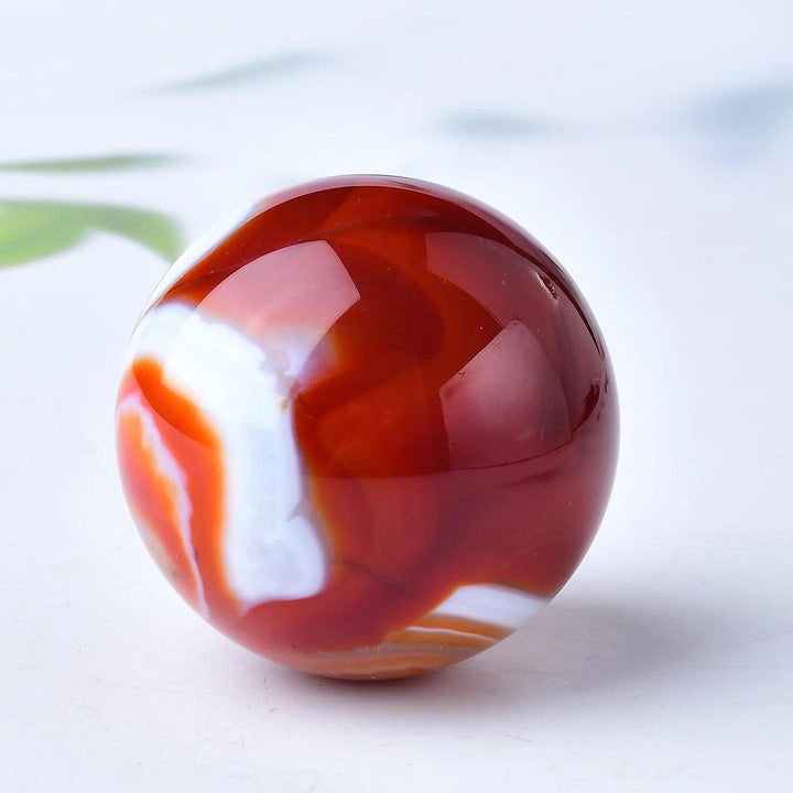 Red Banded Agate Crystal Polished Sphere, showcasing deep crimson, rust, and white layers for grounding and vitality.