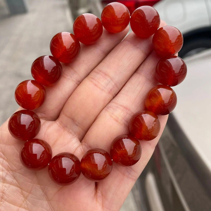 Red Carnelian crystal stretch bracelet with polished burnt-orange beads for grounding energy and vibrant confidence.