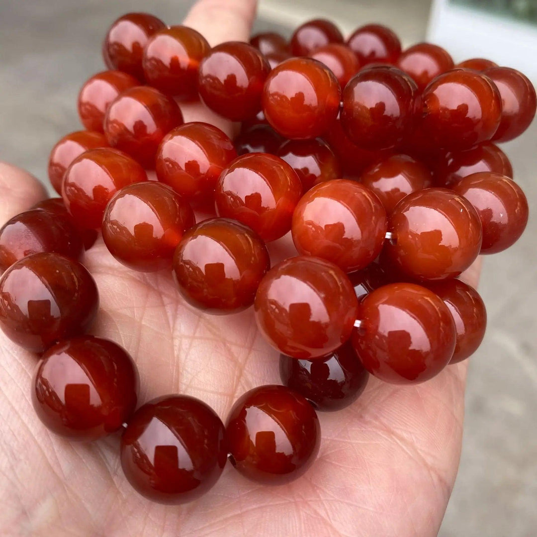 Red Carnelian crystal stretch bracelet with polished, fiery orange beads for grounding energy and confidence.