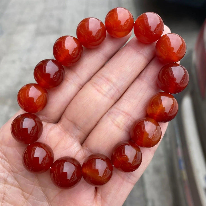 Red Carnelian crystal stretch bracelet featuring polished, burnt-orange beads for grounding energy and vitality.
