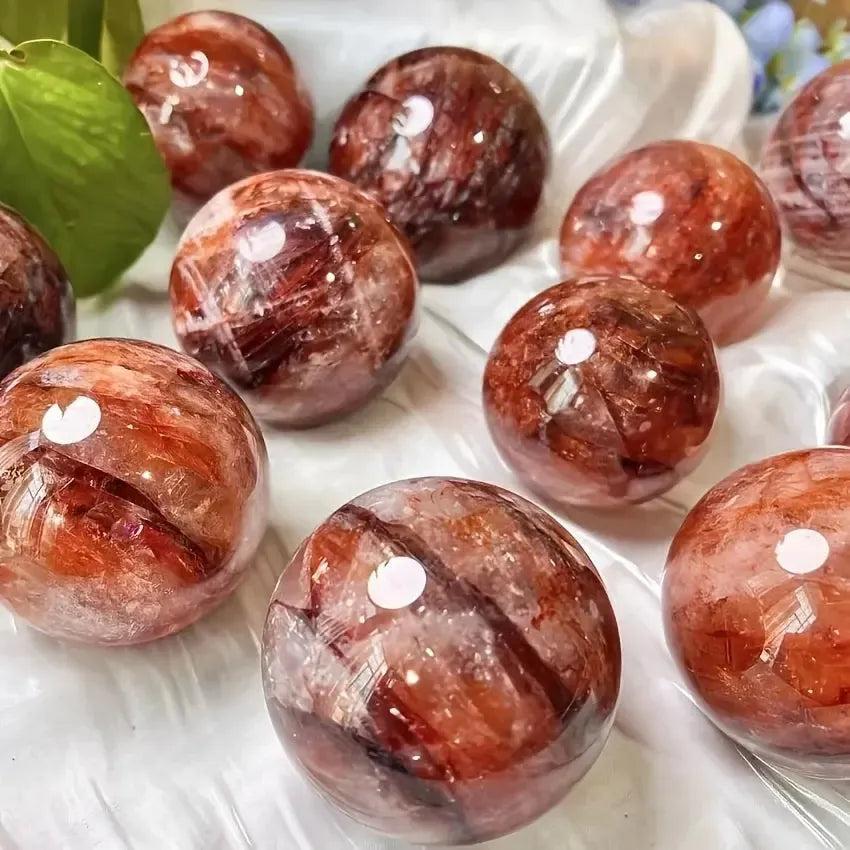 Crystal Destiny Red Hematoid Fire Quartz spheres with fiery red and orange inclusions, promoting vitality.