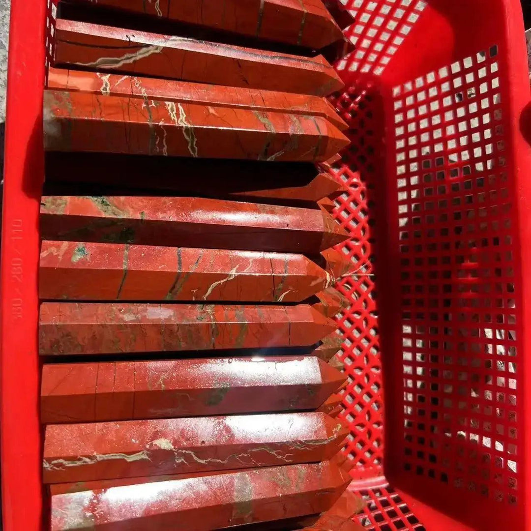 Polished Red Jasper Crystal Towers from Crystal Destiny, showcasing earthy red tones and natural white veins in a red basket.