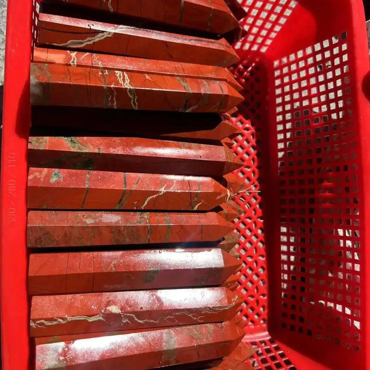 Polished Red Jasper Crystal Towers from Crystal Destiny, showcasing earthy red tones and natural white veins in a red basket.