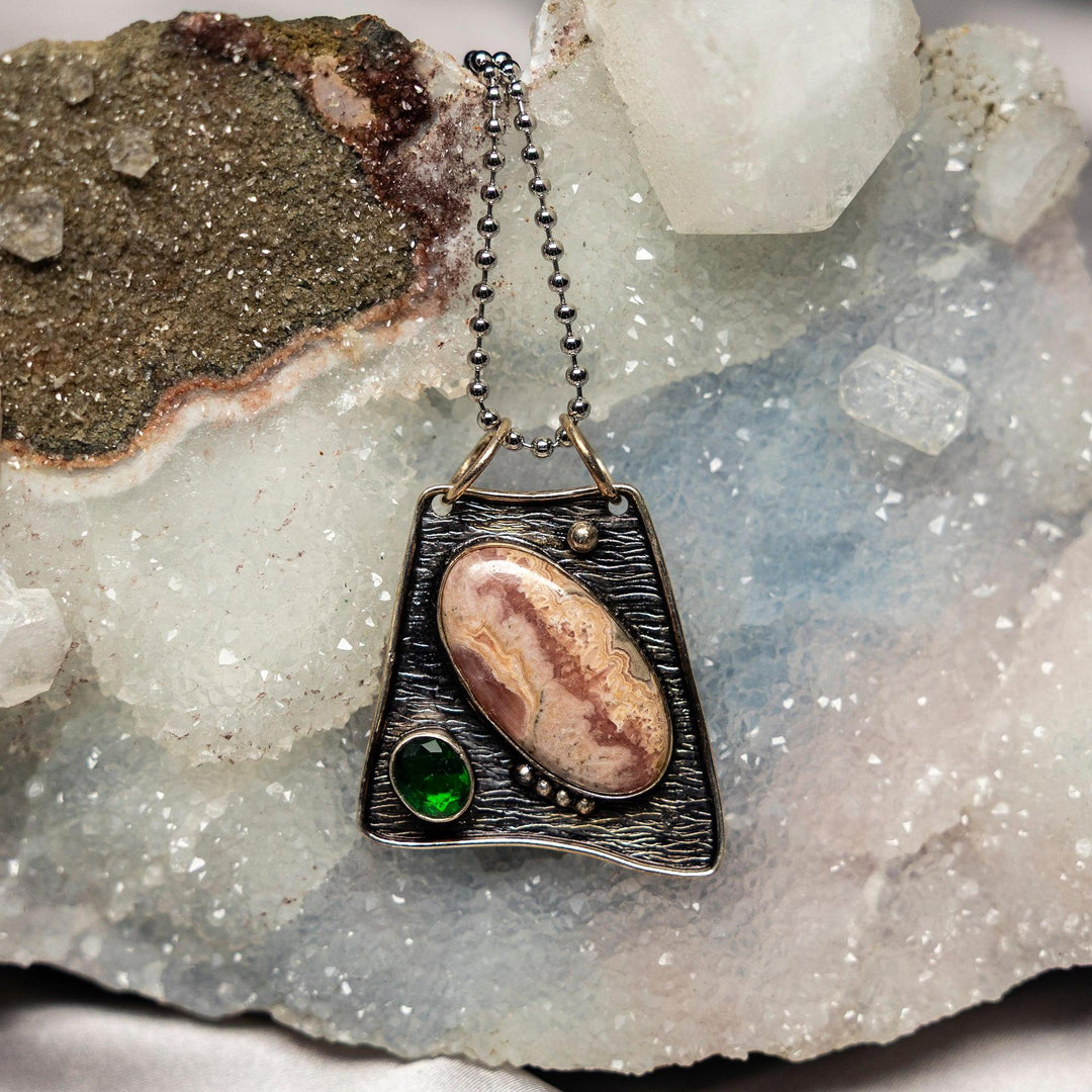 Rhodochrosite 925 Sterling Silver Pendant with a beautiful pink banded stone and a vibrant green accent.
