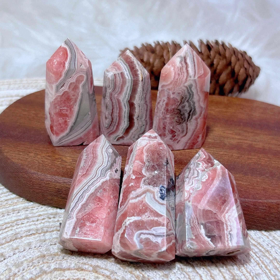Polished Rhodochrosite tower points featuring beautiful rose pink and white banding for heart chakra healing.