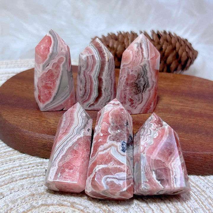 Polished Rhodochrosite tower points featuring beautiful rose pink and white banding for heart chakra healing.