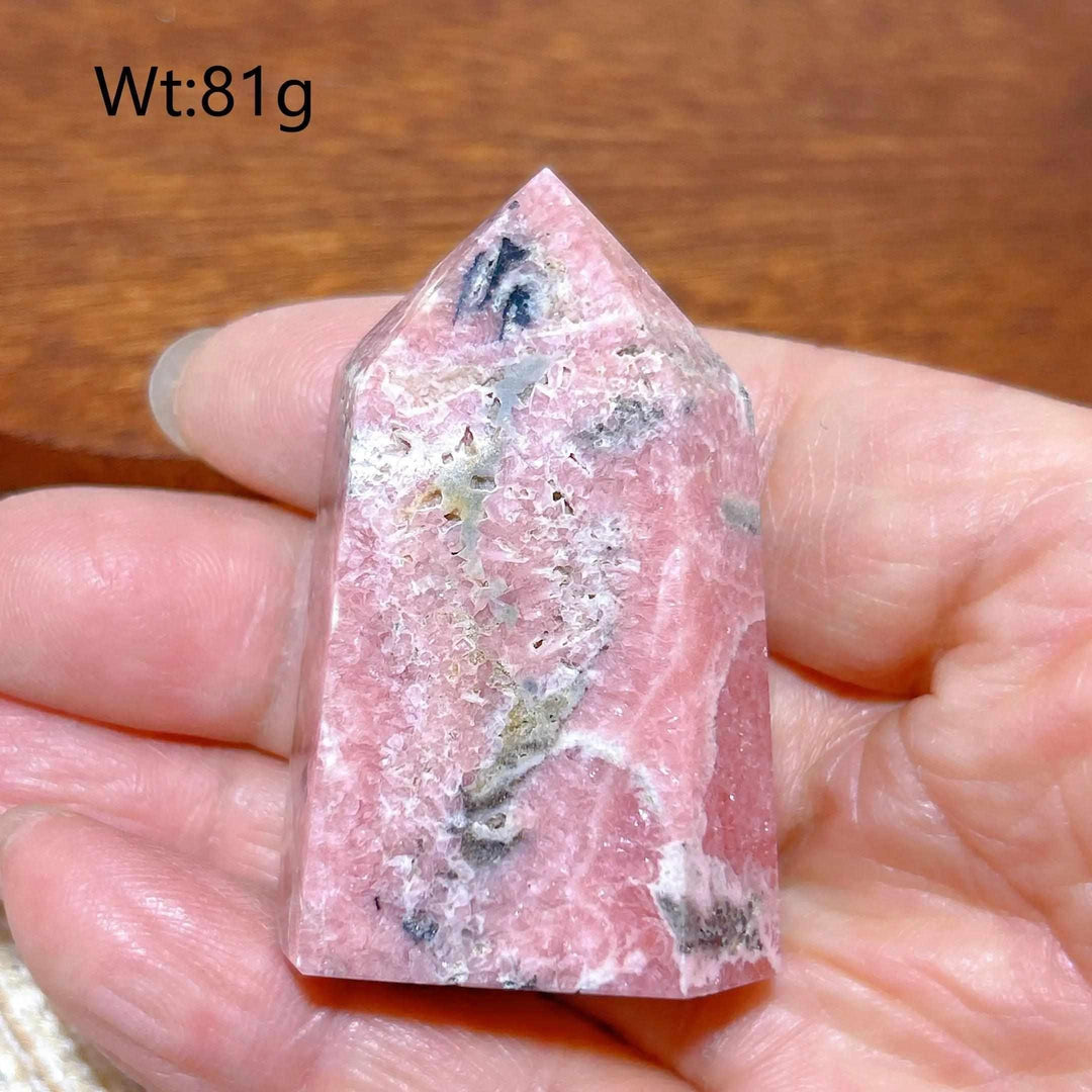 Polished 81g Rhodochrosite tower point featuring beautiful rose pink hues and white banding for heart chakra healing.