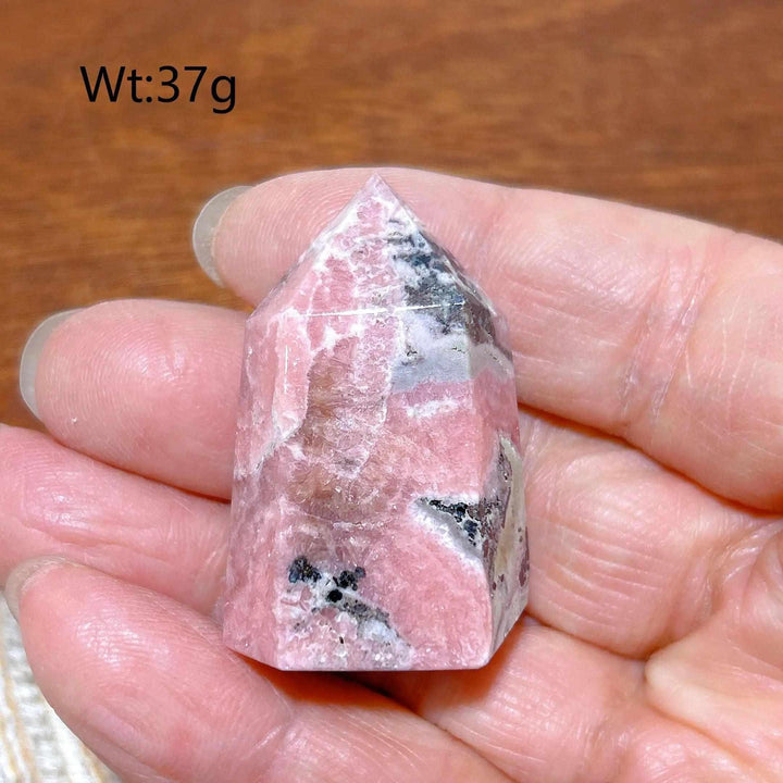 Polished 37g Rhodochrosite tower point featuring beautiful rose pink hues and white banding for heart chakra healing.
