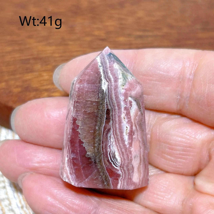 Polished 41g Rhodochrosite tower point featuring beautiful rose pink and white banding for heart chakra healing.