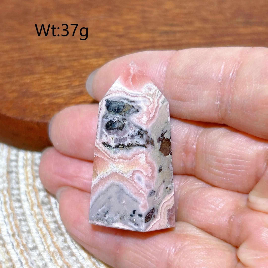 Polished 37g Rhodochrosite tower point featuring beautiful rose pink and white banding for heart chakra healing.