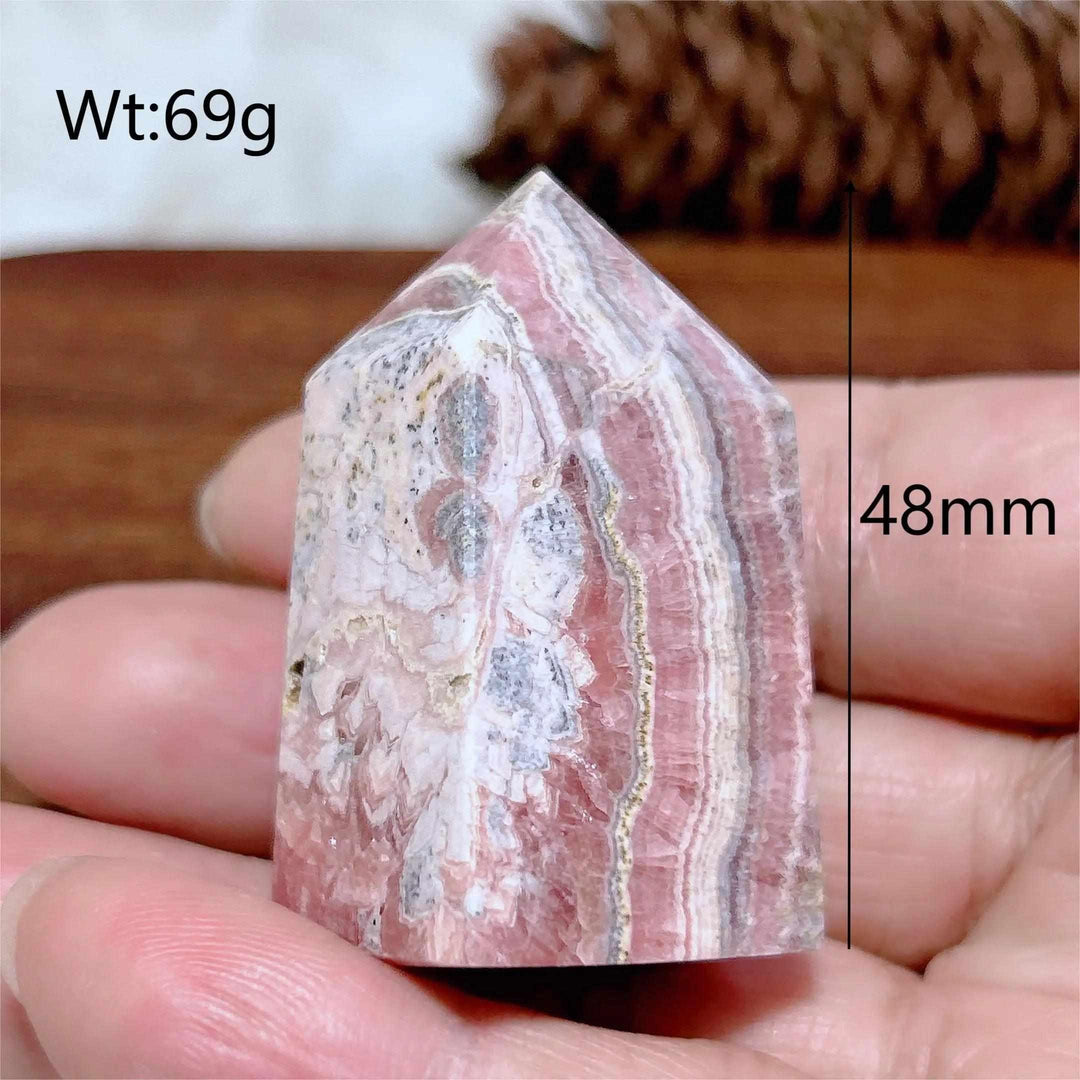 Polished 48mm Rhodochrosite tower point featuring beautiful rose pink and white banding for heart chakra healing.