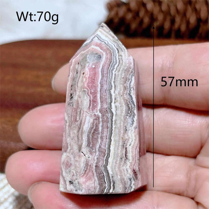 Polished 57mm Rhodochrosite tower point featuring beautiful rose pink and white banding for Heart Chakra healing.