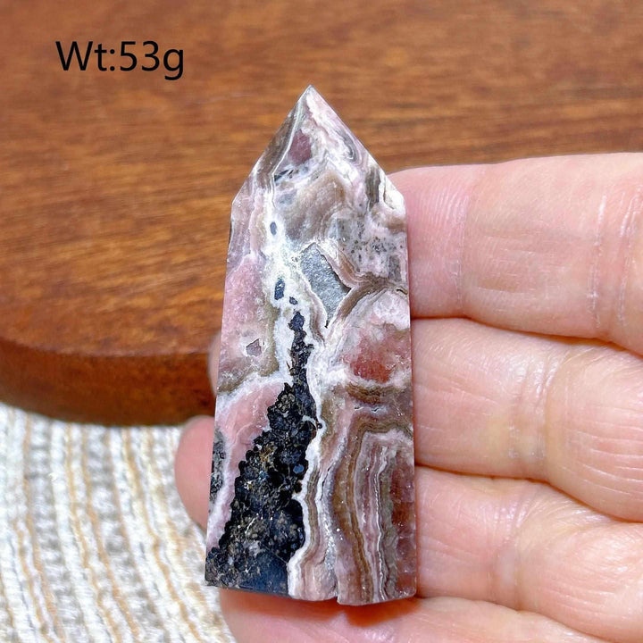 Polished 53g Rhodochrosite tower point featuring beautiful rose pink and white banding for heart chakra healing.