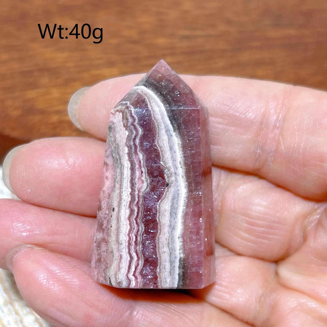 Polished 40g Rhodochrosite tower point featuring beautiful raspberry pink and white banding for heart chakra healing.