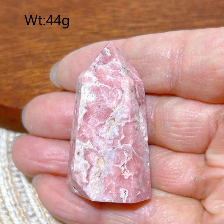 Polished 44g Rhodochrosite tower point featuring beautiful rose pink hues and soft white banding for heart chakra healing.