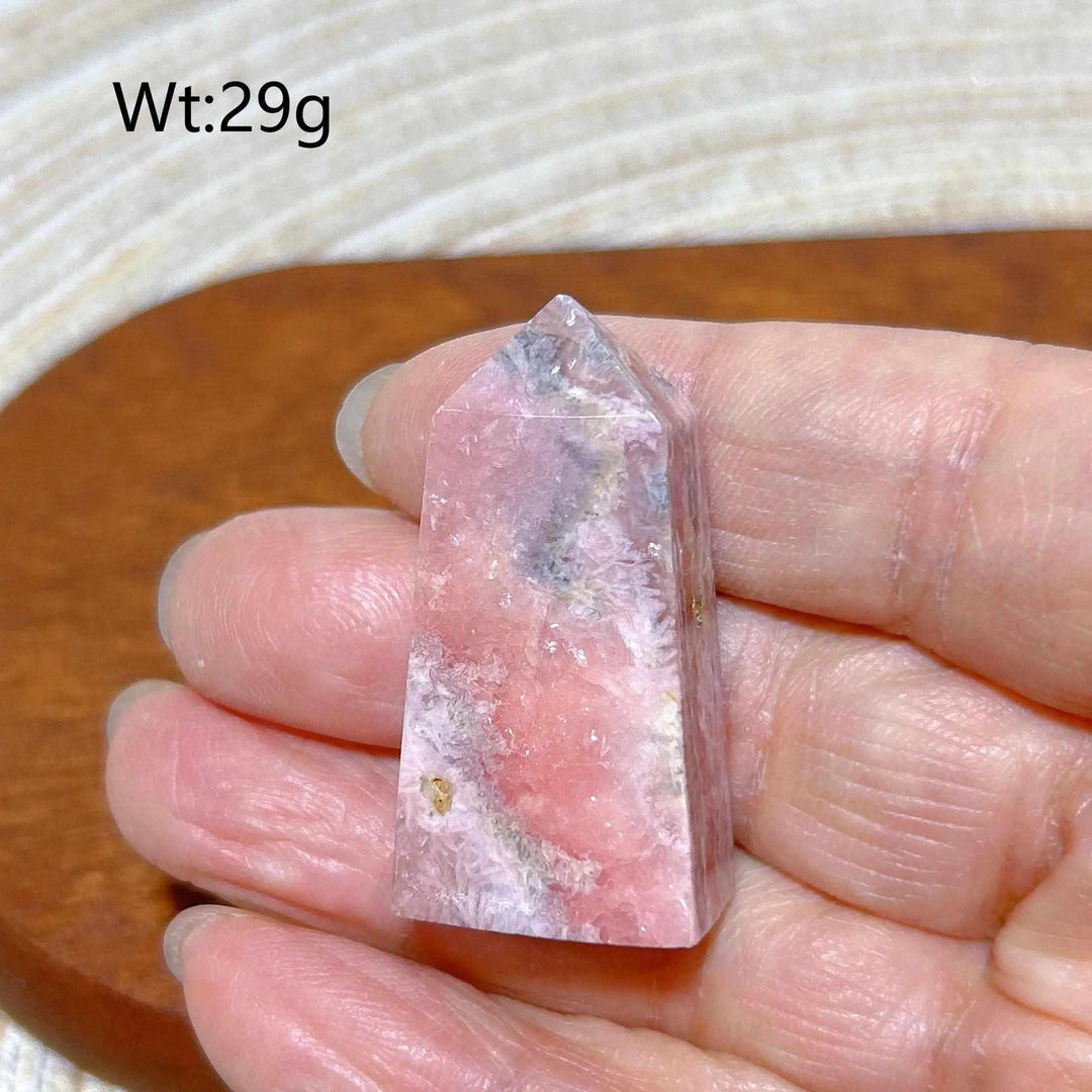 Polished 29g Rhodochrosite tower point featuring beautiful rose pink and white banding for heart chakra healing.