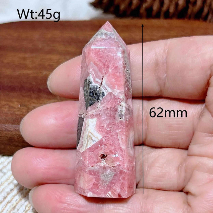 Polished 62mm Rhodochrosite tower point featuring beautiful rose pink hues and white banding for heart chakra healing.
