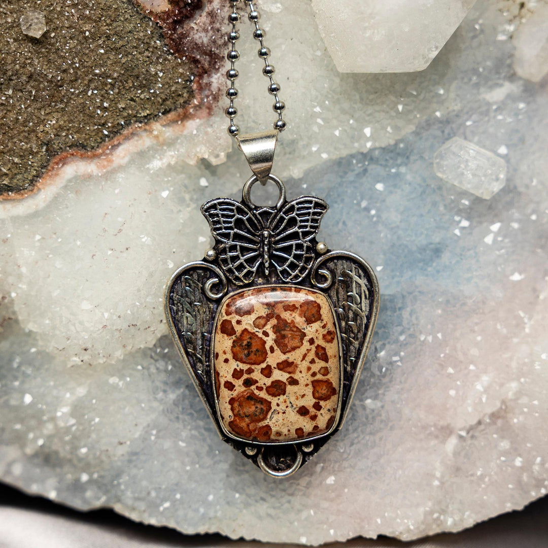 Rhyolite 925 Sterling Silver Pendant with a unique landscape pattern, set in an ornate butterfly design.