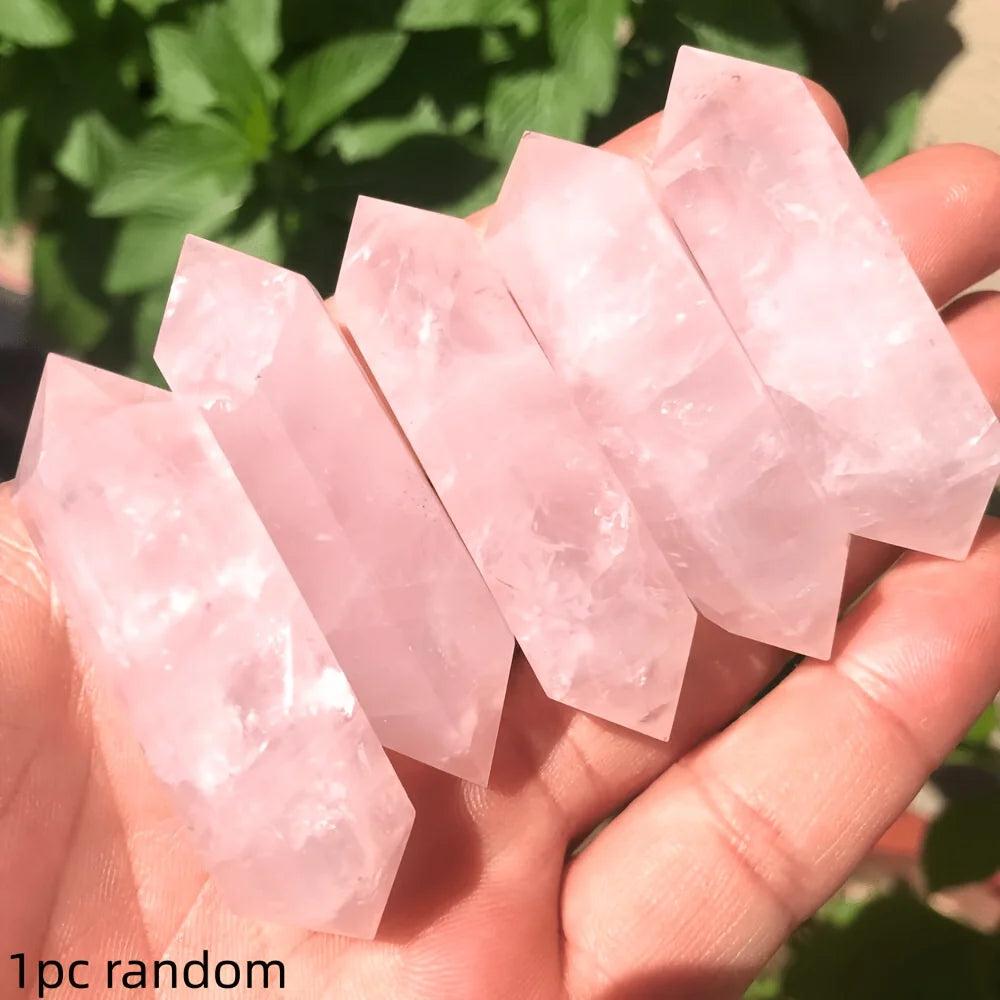Five pink Rose Quartz Crystal Double Point Wands held in a hand for heart healing energy.