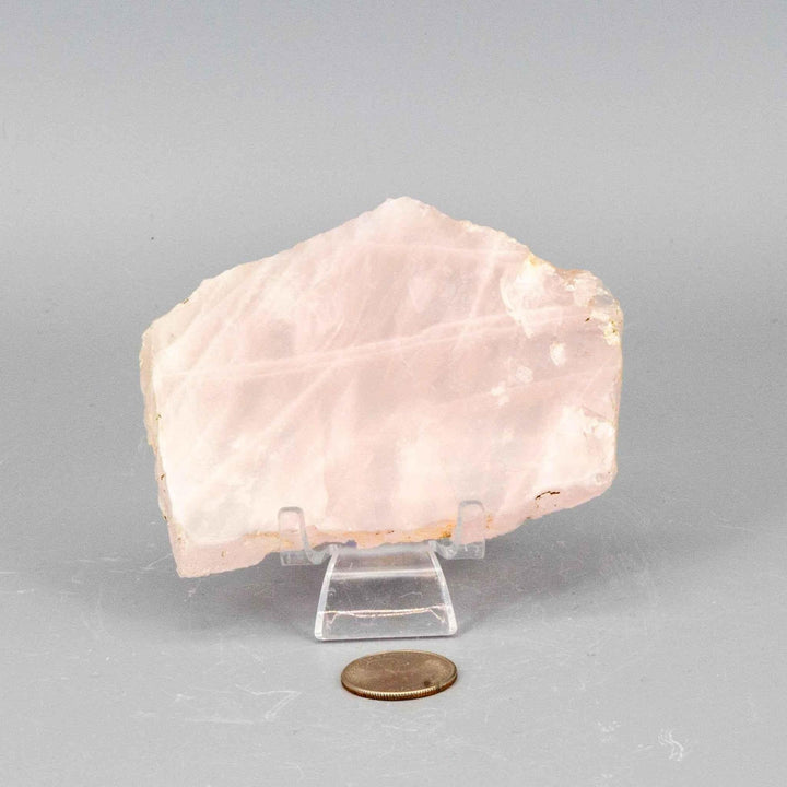 Polished Rose Quartz Slice: translucent pink crystal with natural edges, perfect for display or altar.