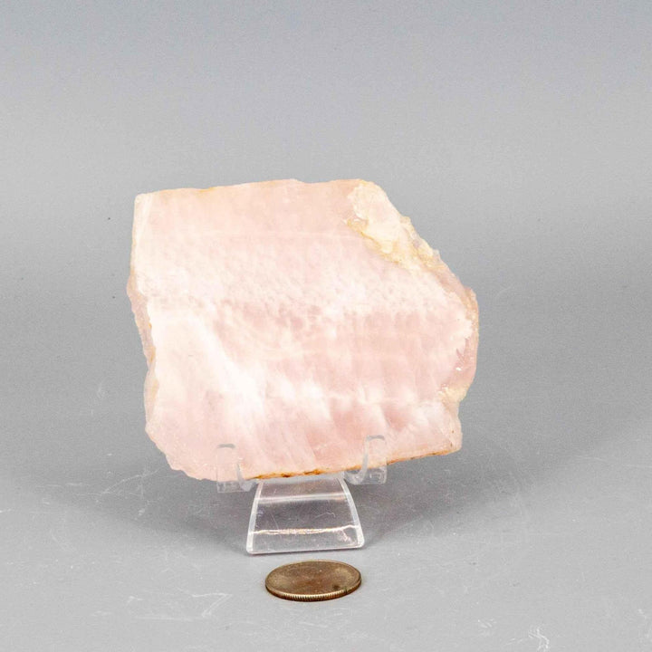 Rose Quartz Slice: Polished, translucent pink crystal with natural edges, revealing its soft, diffused glow.