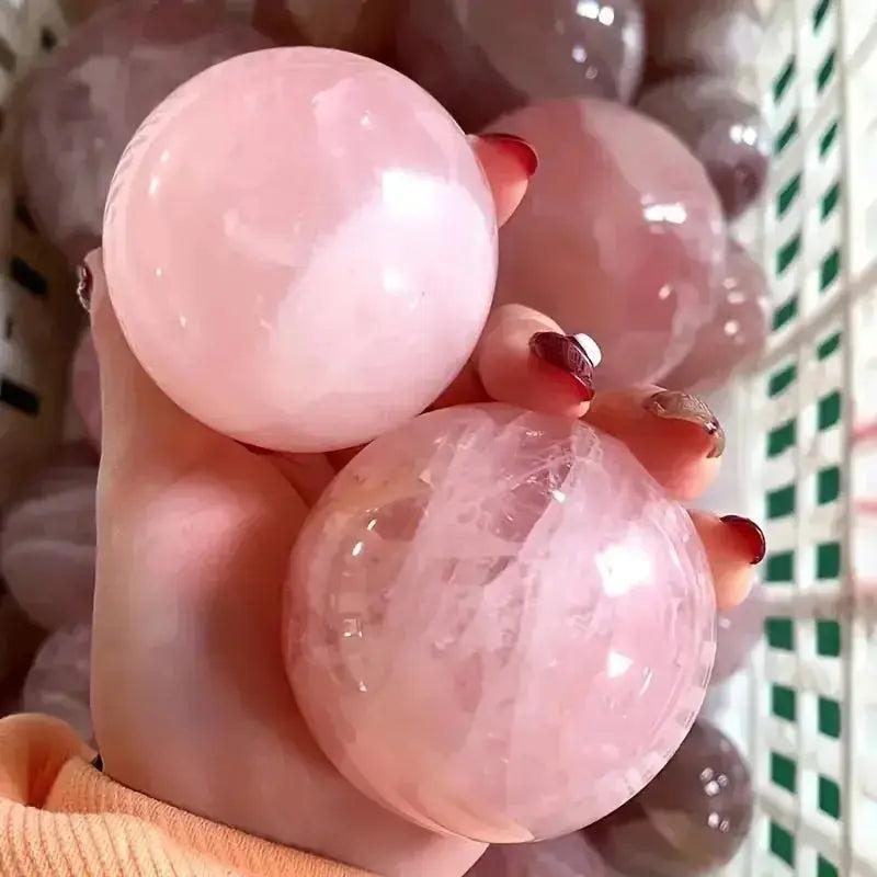 Polished Rose Quartz Crystal Spheres in soft pink, radiating unconditional love and gentle energy.